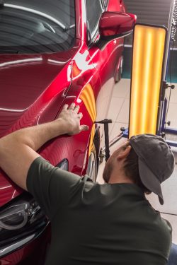 man repairing car body